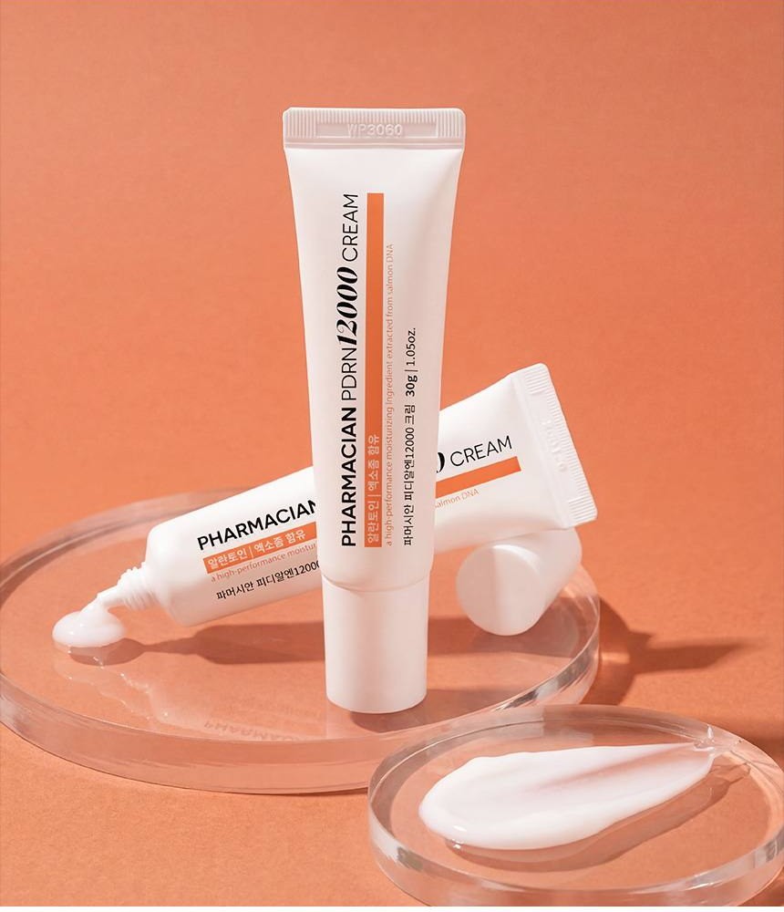Pharmacian PDRN12000 cream tubes on glass with a cream swatch