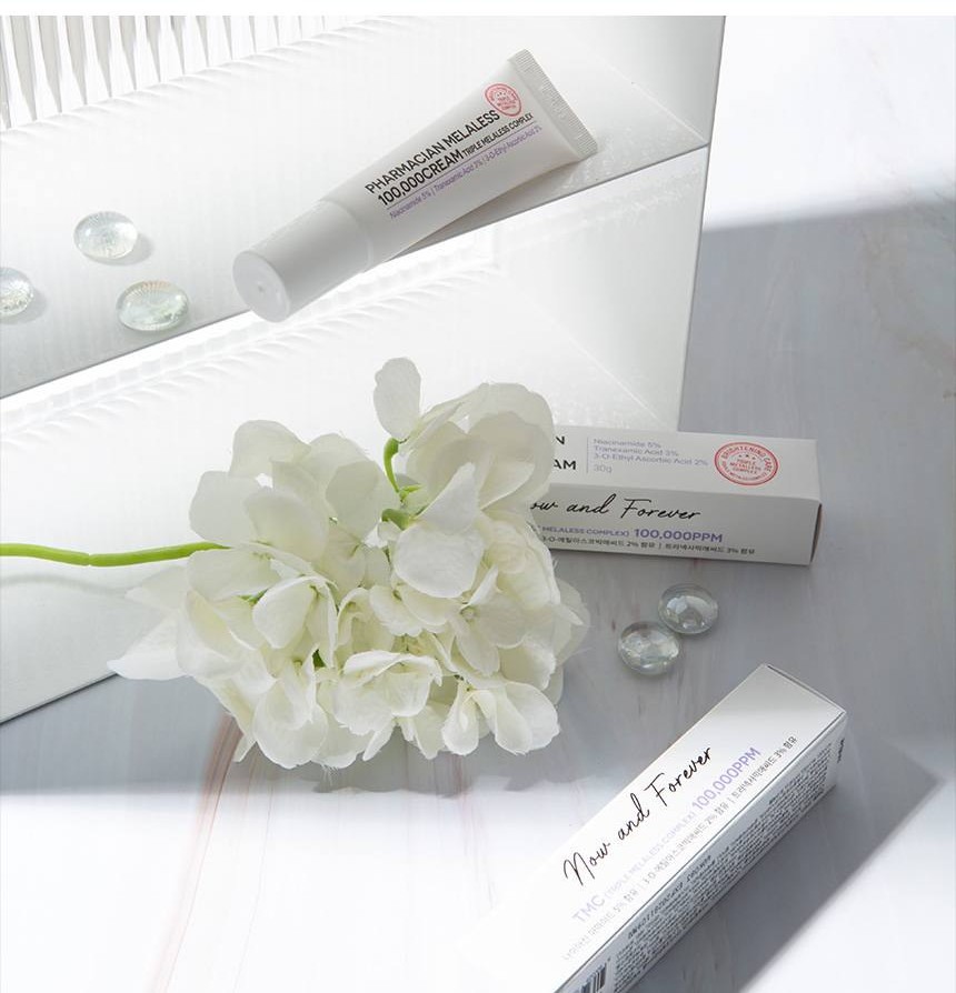 Pharmacian MELALESS 100,000 cream and box with white flowers