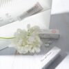 Pharmacian MELALESS 100,000 cream with white flowers