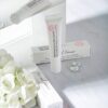 Pharmacian MELALESS 100,000 cream tubes and boxes with white flowers