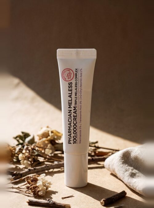 Pharmacian MELALESS 100,000 cream tube on linen with dried botanicals Pharmacian MELALESS 100,000 cream tube on linen with dried botanicals