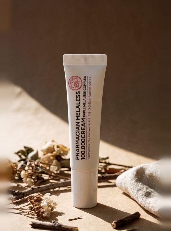 Pharmacian MELALESS 100,000 cream tube on linen with dried botanicals Pharmacian MELALESS 100,000 cream tube on linen with dried botanicals