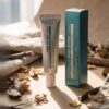 Pharmacian NMN30000 cream tube and box on linen Pharmacian NMN30000 cream tube and box on linen