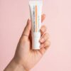 Hand holding a tube of Pharmacian PDRN12000 cream Hand holding a tube of Pharmacian PDRN12000 cream